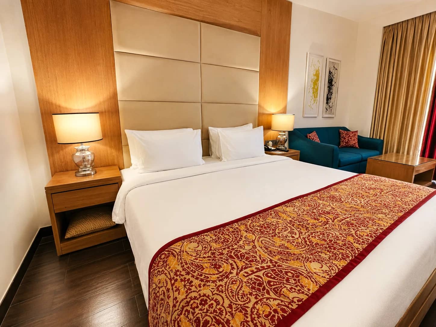 King bed with a wine-red runner in the Deluxe Room