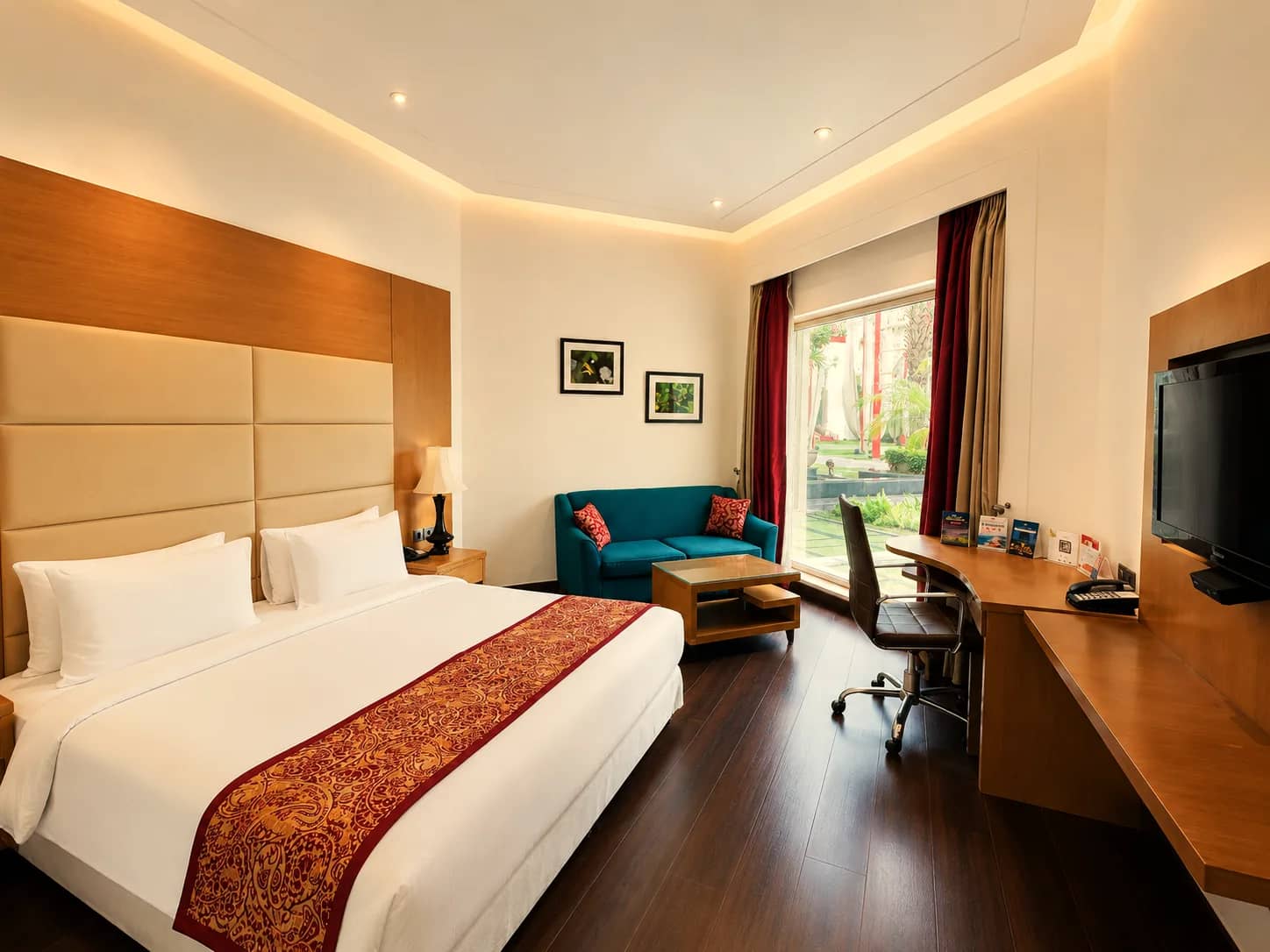 Deluxe Room with king bed, sofa and garden window