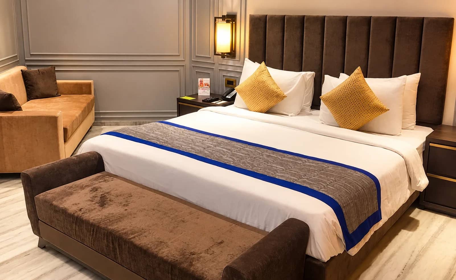 Luxury Suite with a velvet headboard and bench