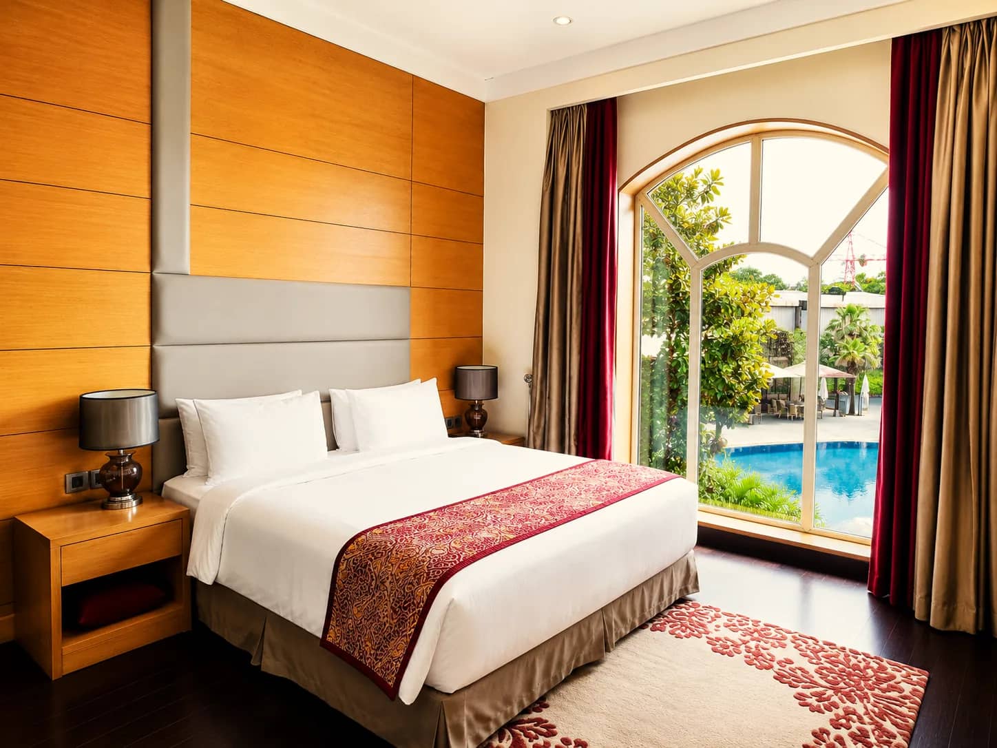 Presidential Suite bedroom with an arched window over the pool